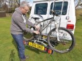 A bike being attached to a bike rack