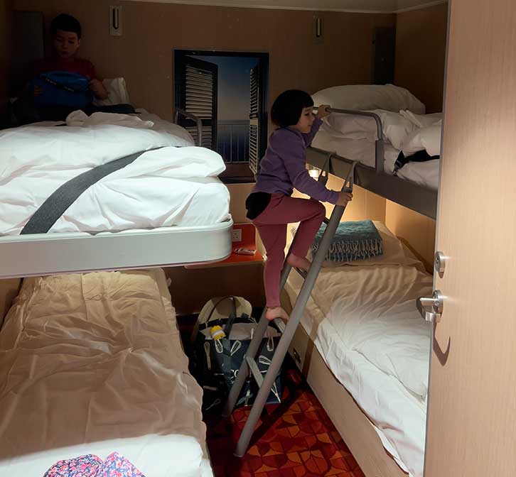 Child climbing into top bunk bed
