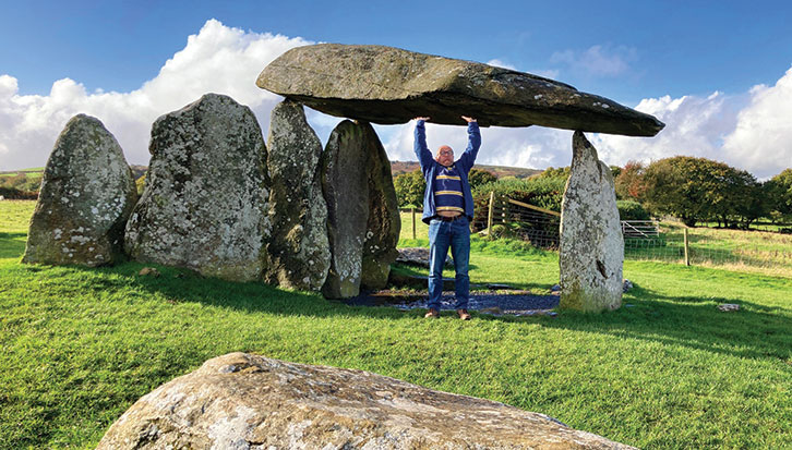 Man by Neolithic burial chamber