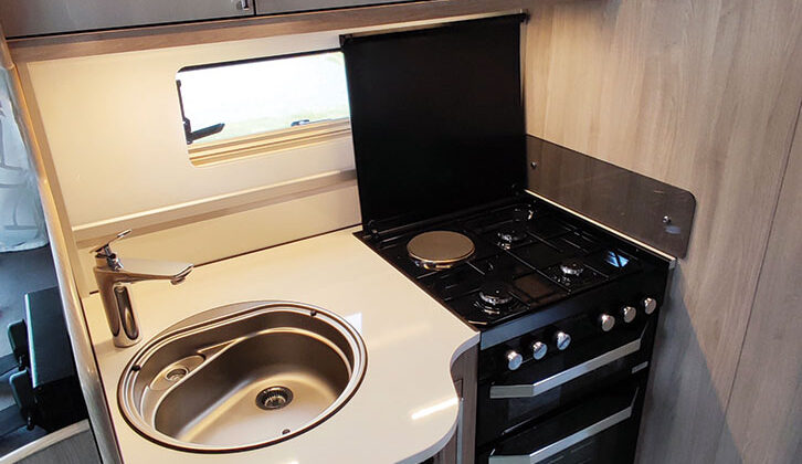 Kitchen with sink and cooker