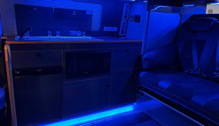 Interior of Motion R campervan lit up with blue interior lighting