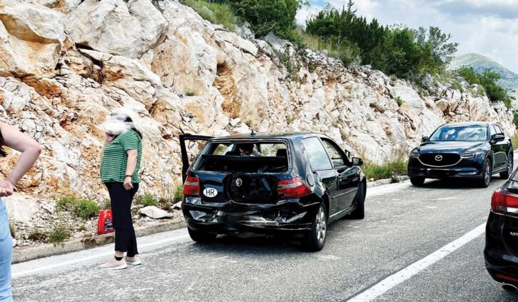 Crashed car on left side of the road