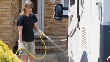 A person rinsing down a motorhome