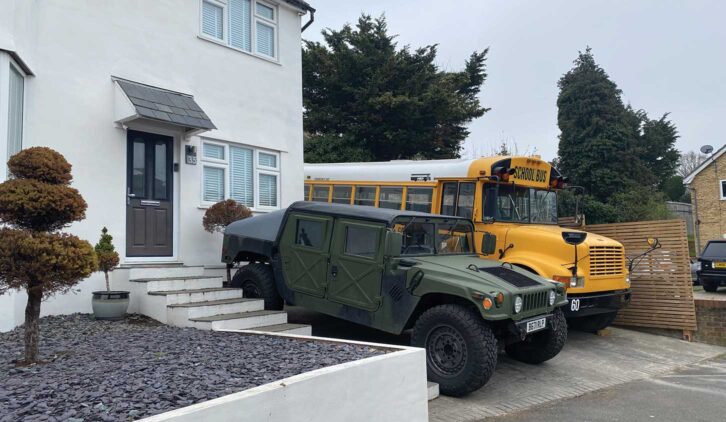 Humvee and bus on driveway