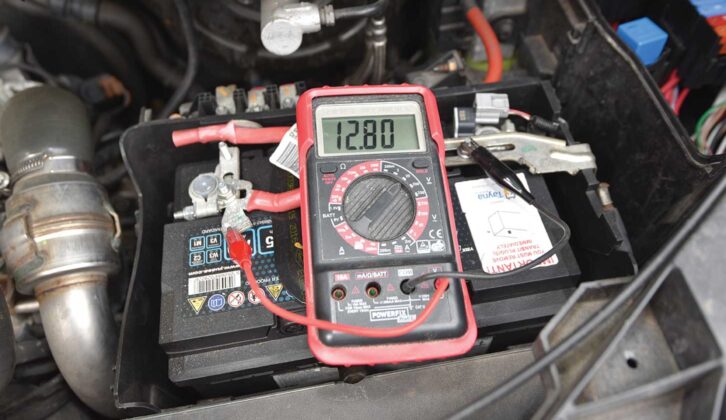 Multimeter measuring the starter battery voltage