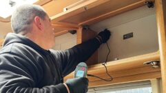 Damp being tested for in a cupboard