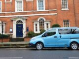 A Nissan NV200 on a street