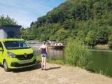 A pitched up campervan by water