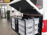 The optional pull-out storage system with boxes on the rear panel