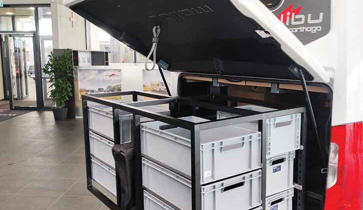 The optional pull-out storage system with boxes on the rear panel