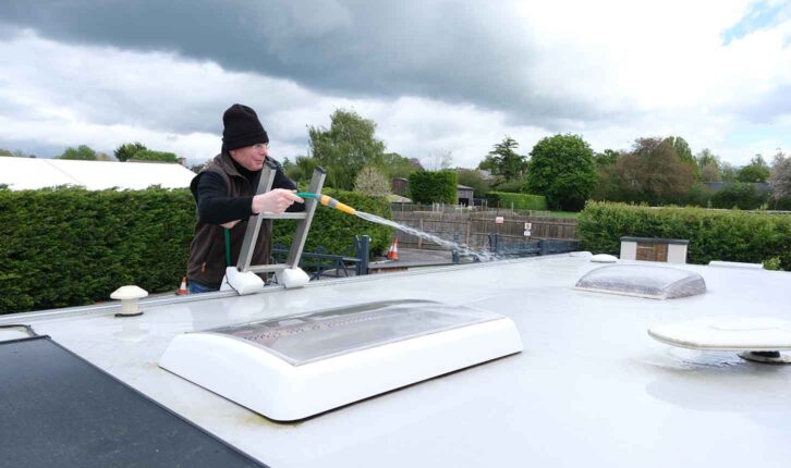 Andrew using the hose on the roof