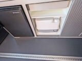 A Porta Potti being stored in a cupboard
