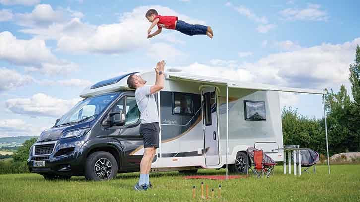A family having fun by a motorhome