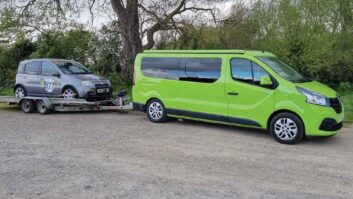 A campervan towing a Fiat Panda 100hp