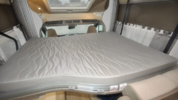 A double mattress on a drop-down bed in a motorhome.