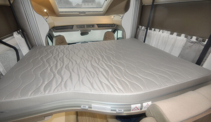 A double mattress on a drop-down bed in a motorhome.