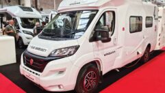 A Wingamm motorhome at a show with a 7 year warranty sticker on it