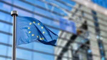 uropean Union flags in front of the blurred European Parliament in Brussels, Belgium