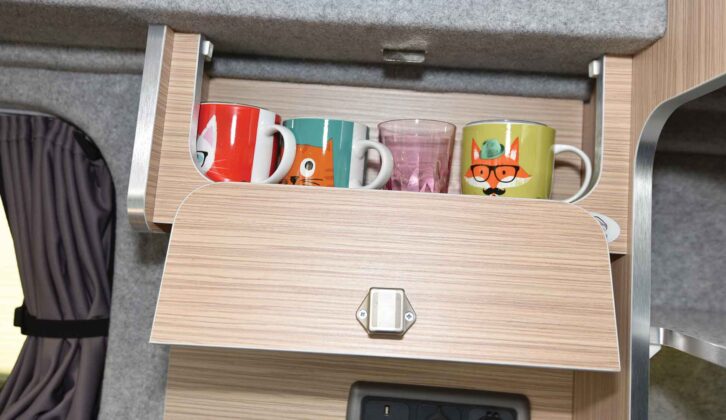 A cupboard with mugs and glasses