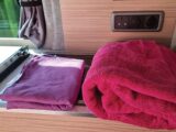 A microfibre towel next to a domestic towel