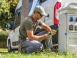 A man setting up electric hook-up for his campervan