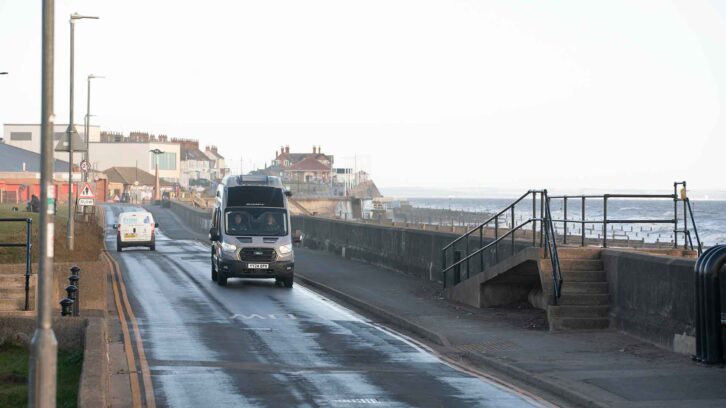 A Swift Trekker X being driven along the seafront