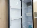 A fridge with its door open to let air circulate