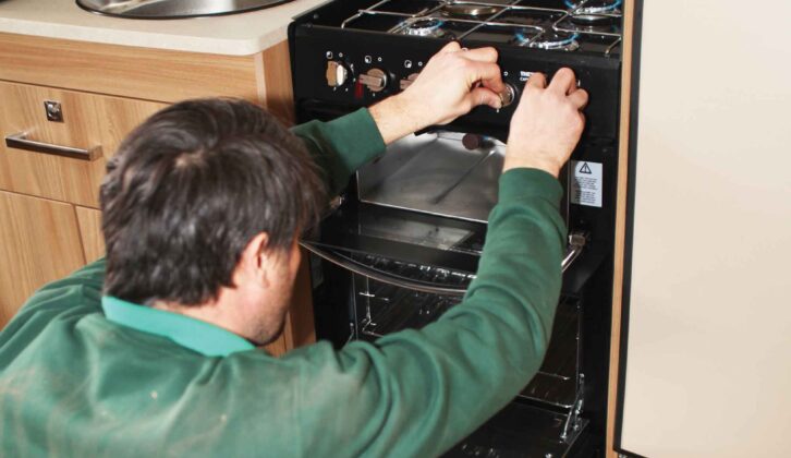 A technician checking the burn and the cut-off of the cooker