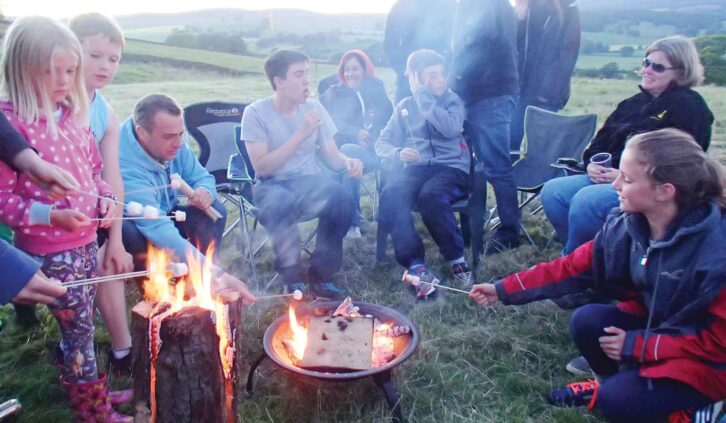 People gathered around the fire pit