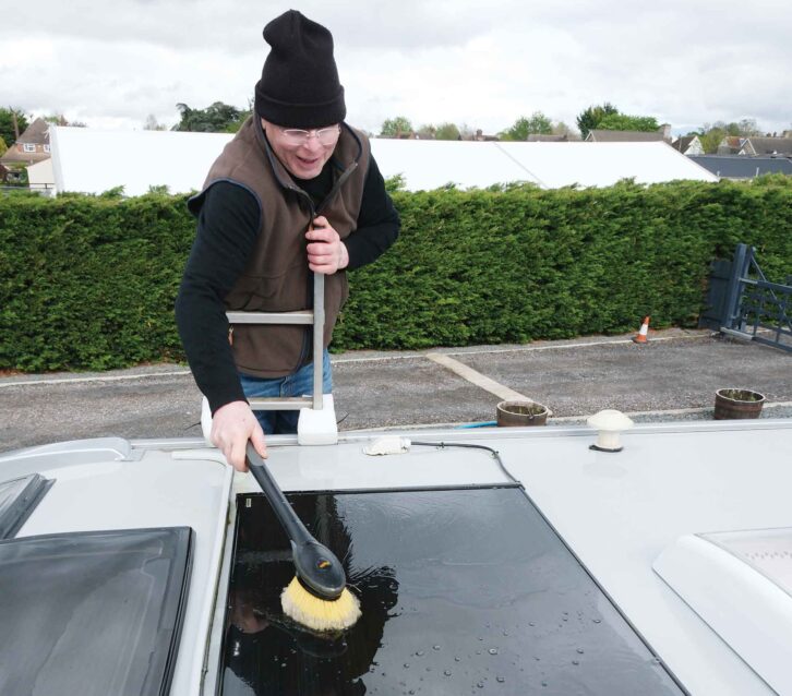 Cleaning a roof-mounted panel