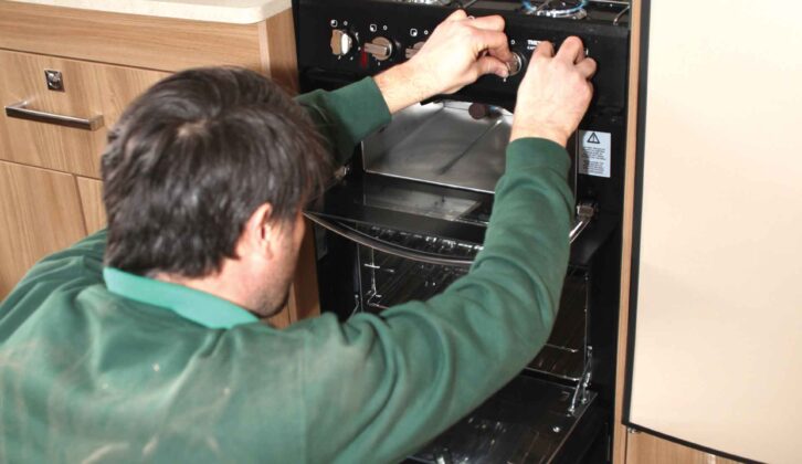 A cooker being serviced by a technician