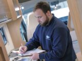 A technician filling in a form