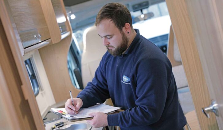A technician filling in a form