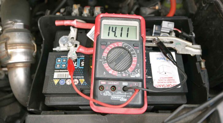 A multimeter showing a reading of 14.11V