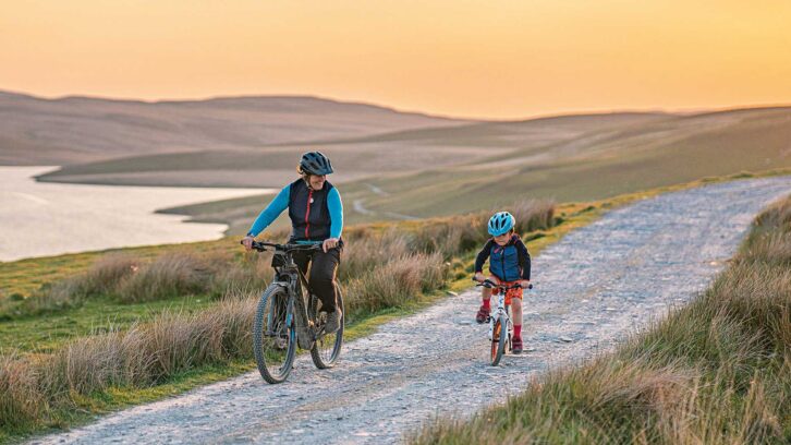 A father and son cycling in the Cambrian Mountains