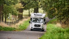A motorhome being driven down a road in the Cotswolds