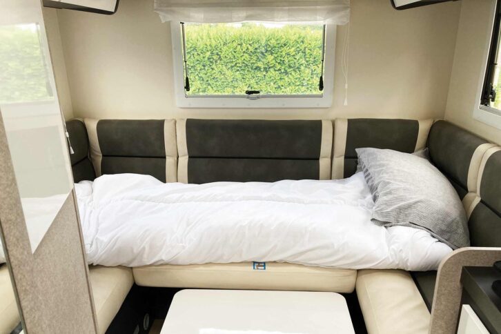 The single bed in the rear lounge