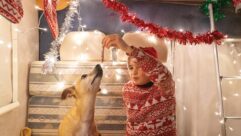 A child and a dog in a motorhome decorated for Christmas
