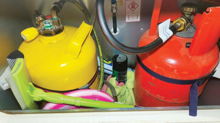 A pink Frisbee and a spray can in a gas locker