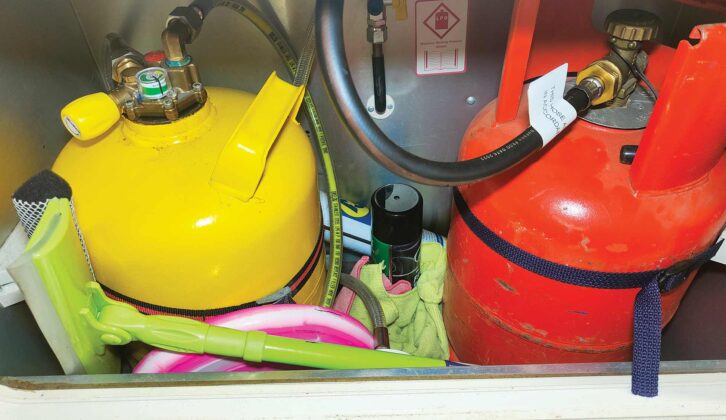A pink Frisbee and a spray can in a gas locker