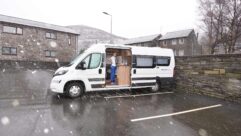 A campervan in a parking bay on a wet day