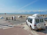 A campervan parked up on a beach