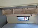 Overhead lockers above the bed