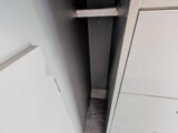 The hanging space for clothes beneath the rear bed