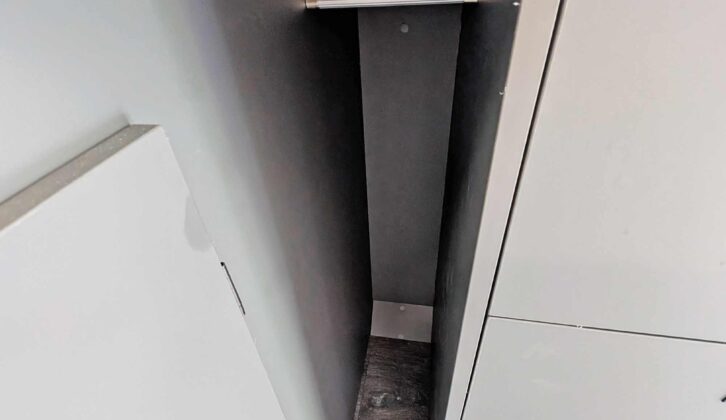 The hanging space for clothes beneath the rear bed