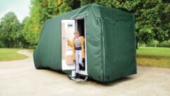 A person getting out of a motorhome which has a cover on