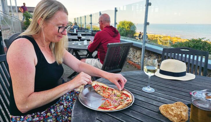 Helen eating a pizza