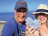 Peter and Helen holding a heart-shaped rock