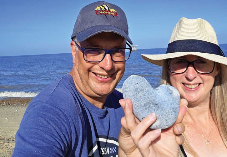 Peter and Helen holding a heart-shaped rock