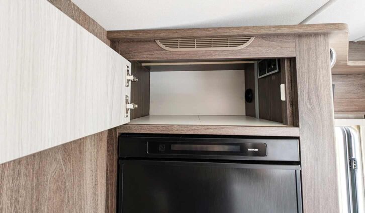 The cupboard above the slimline fridge